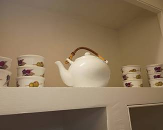 White porcelain teapot with bamboo handle, floral teacups, tea set collection