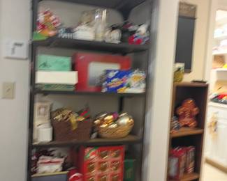 Christmas decorations shelving lot, holiday collectibles, Santa figurines, kitchen items, household goods assortment, storage shelf