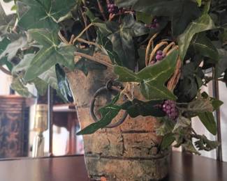 Live houseplant in decorative ceramic planter pot on wood table