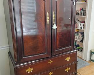 Dark wood armoire wardrobe, brass hardware, panel doors, drawers, bedroom furniture