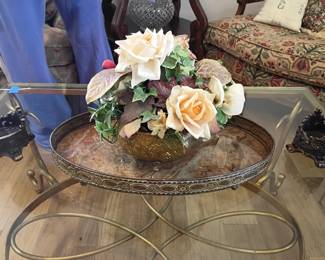 Glass top round coffee table, gold metal base, silk rose flower arrangement, living room furniture