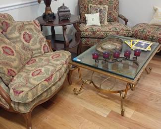 Floral upholstered armchairs, ottoman, glass top coffee table, gold base, living room set