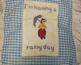 Vintage cross-stitch embroidery on gingham, rainy day motif, handmade needlework