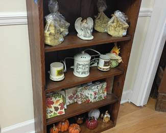 Wooden display bookshelf with collectibles, snow globes, figurines, knick knacks