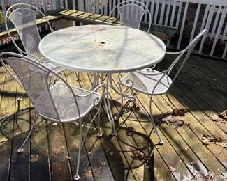 Round metal patio table with glass top and 4 chairs 