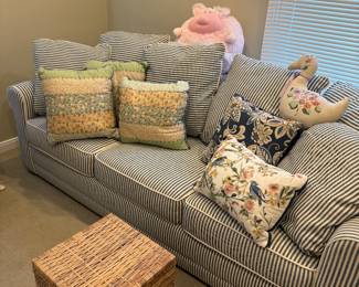 3-cushion couch - sleeper sofa, pillows and wicker storage cube