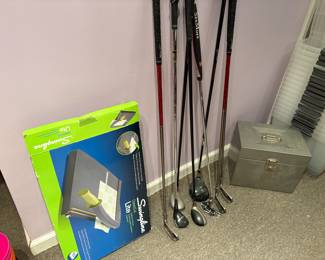 Golf clubs and Swingline paper cutter