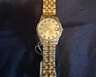 BULOVA WATCH FEATURING A CHAMPAGNE DISL WITH 11 DIAMOND MARKERS