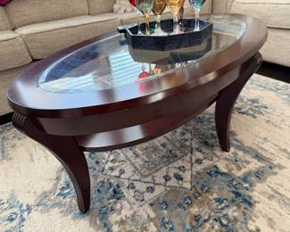 Dark cherry, wood frame with glass top oval coffee table 50 x 30 x 18