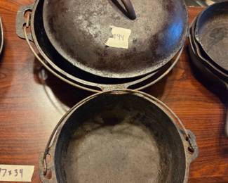 #94	Cast Iron Dutch Oven w/Smaller Dutch oven both with metal handles and one lid - Needs Seasoning and cleanup	 $45.00 