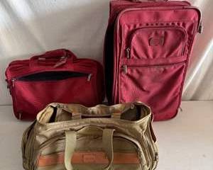 Two TUMI Travel Bags Including Red Rolling Suitcase, Red Carry-On, and Beige Duffel Bag