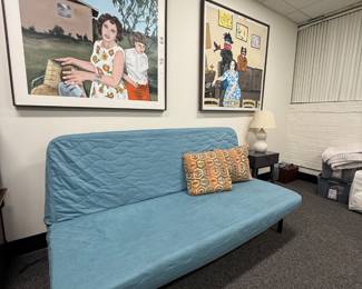 Ikea couch that can fold down into a bed. Original painted artwork depicting old photos 
