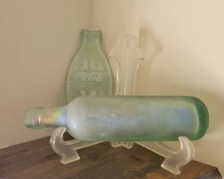 rounded bottom bottle, flattened Coca Cola bottle