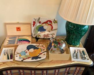Claude Dozorme steak knife set, studio pottery plates by Dwo Wen Chen, Kitras art glass orb, Maitland Smith faux malachite lamp