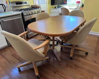 Vintage extension dining table with 7 rolling chairs - 5 arm - 2 sides 