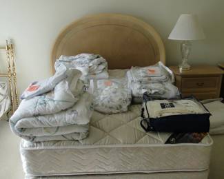 Queen bed with some outstanding sets of sheets and comforters too