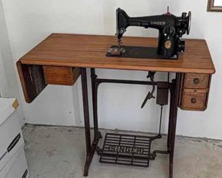 Antique Singer sewing machine with booklet, work receipts, extra parts