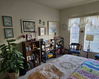 quilted bed spread, quilts, silk plants, framed wall art, pair of wooden chairs this room is full! 