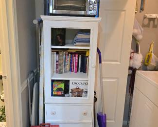 Toaster oven, cute what cabinet with glass front and 2 drawers, cookbooks (some vintage)