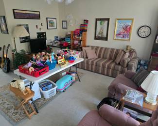 room full of collectibles, vintage toys, sleeper sofas, recliners, TV, wall decor, and so much more