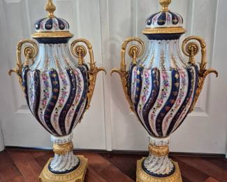 Porcelain lidded urns measure 32"