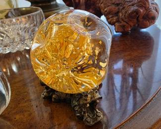 Alaskan gold flakes in water ball on hippo stand.