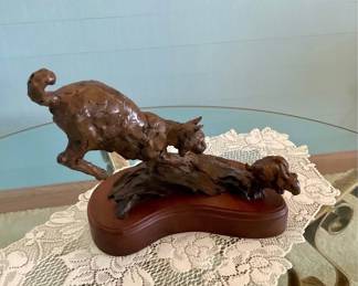 Bronze bobcat statue, "The Chase is Over", mounted on solid cherry base