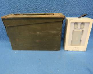 Lot 74. Metal ammo can with a set of wireless ear buds