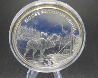 Lot 253. Les Kouba Tribute "Moose Family Up North" Commemorative Coin. Includes a COA stating it is a total of 4.5 ounces and Clad in .999 pure silver and selectively layered in 24k gold.