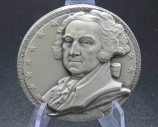 Lot 307. Medallion weighing 2.274 troy ounces of .999 pure silver from The Hall of Fame for Great Americans Series featuring John Adams. Made by the New York Medallic Art Co.