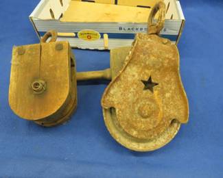Lot 441. Two old pullies, one is cast iron and one is wooden, plus a wooden mallet