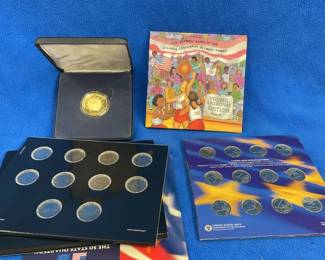 Lot 159. Two 2010 America the Beautiful quarters, five state quarters and 12 euros, U.S. Olympic Young Collectors Series #1 coin, and a Pearl Harbor Medallion.