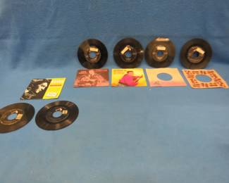Lot 255. Six Elvis Presley 45s. Four with sleeves, two without sleeves, and one empty sleeve.