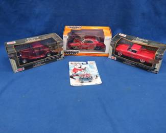 Lot 369. Three 1:24 scale Die Cast cars and a Hot Wheels car all in the original packaging