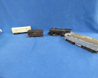 Lot 425. Four old railroad cars: Lionel Union Pacific 2023 locomotive that works. Lionel Lines tender car that works. Lionel steam locomotive #1684 that works. Lionel Automated refrigerator car #3472 with a detached side door.