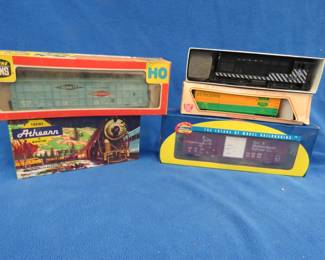 Lot 445. Four model train cars and one locomotive, as shown in photos.