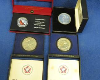 Lot 49. Four Canadian coins: 2008 Canadian 50-cent sterling silver triangle weighing 20 grams. Two 1987 Canadian gold-colored dollars. 2005 Canadian 50-cent sterling coin