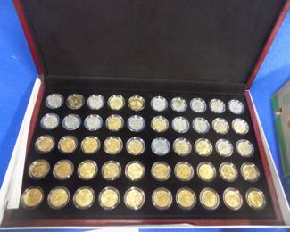 Lot 43. 1999-2008 Philadelphia and Denver uncirculated gold-plated state quarter set. All 50 state quarters included with a display box.