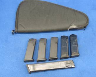 Lot 103. Six Glock 9mm magazines and a soft pistol case