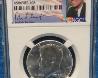 Lot 154. 1964 P Kennedy half dollar. Slabbed and graded MS 64 by NGC.