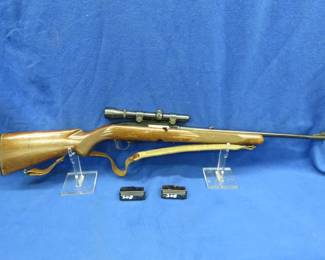 Lot 18. Winchester Model: 100, S/N: 1970, 308 Win, semi-auto rifle. Includes two magazines, a hard case, leather sling, and scope. The finish on the stock is very worn and the barrel has rust and pitting.