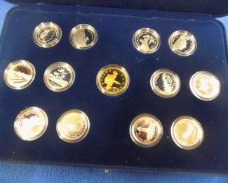 Lot 44. 12 1992 Commemorative Canadian sterling 25-cent coins, each weighing about 6.00 grams, and a Canadian 1992 Commemorative bronze dollar coin.