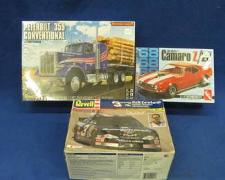 Lot 497. Three model cars ready for assembly: AMT 1968 Camaro Z/28 sealed box. Revell Dale Earnhardt NASCAR #3 open box, but parts are sealed. Revell Peterbilt 359 Conventional sealed box.