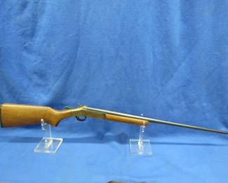 Lot 327. Harrington & Richardson Topper M48, NSN, 410 break-action shotgun with a soft case. The receiver and barrel have rust and the fore grip has pits and dings.