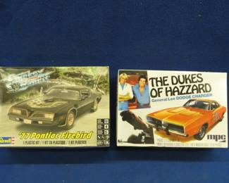 Lot 499. The General and The Bandit model cars. MPC Dukes of Hazzard General Lee, this one has been opened and started (engine assembly) but appears to be complete with decals. Smoley and The Bandit 1977 Pontiac Firebird, box is open parts are sealed