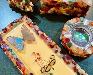 handcrafted, artisan Brazilian epoxy resin crafts, made with polished gemstones and inlaid with real butterflies, including a blue Morpho butterfly, embedded in a resin surface