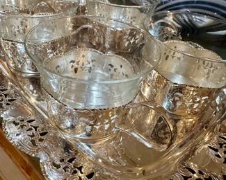 vintage German tea service features six clear glass cups housed in silver-plated holders with open fretwork designs on matching tray