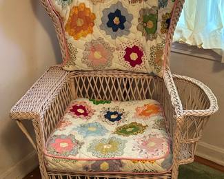 Vintage wicker chair with magazine pouch. Custom quilted cushioned upholsted