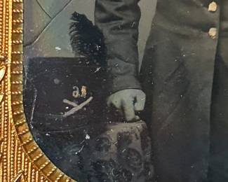 Detail of Hardee hat showing crossed cannon insignia and the regiment number "16" 