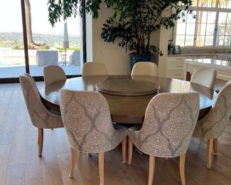Lovely 8’ round dining table with lazy Susan and with 8 chairs